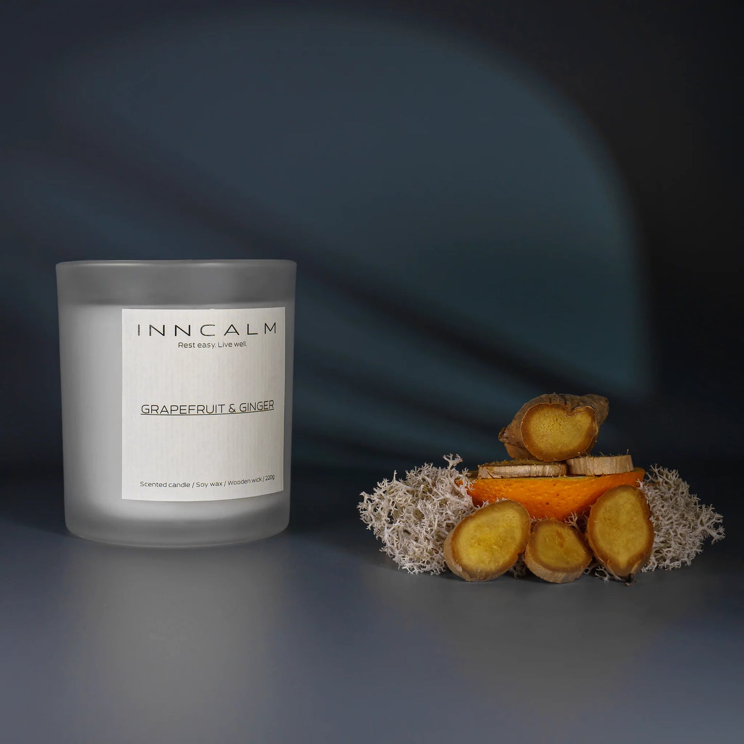 Grapefruit & Ginger scented candle in a glass jar, a spicy-citrus blend made with natural soy wax and a wooden wick