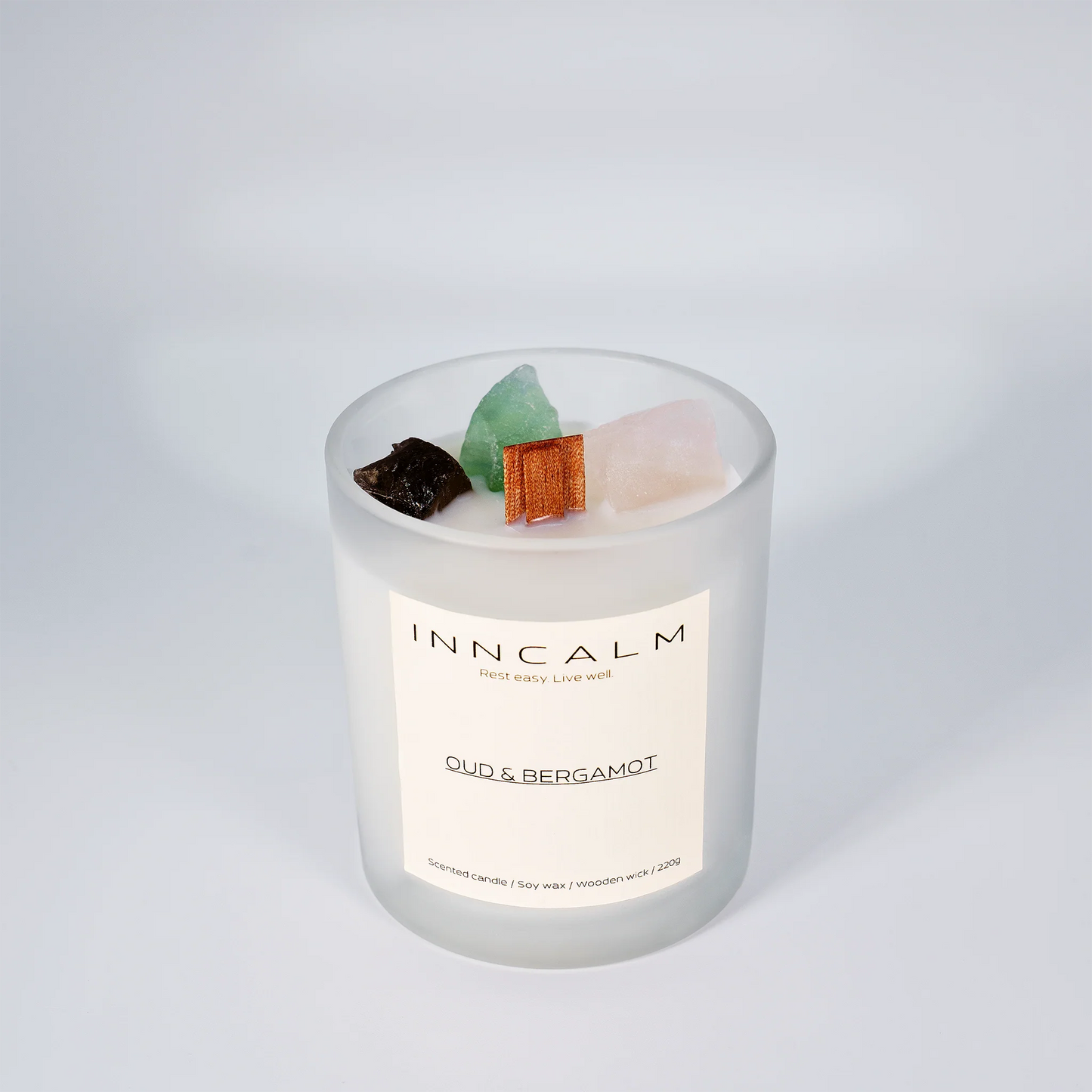 INNCALM Oud & Bergamot luxury candle, rich fragrance with a warm, slightly spicy undertone, featuring a wooden wick.