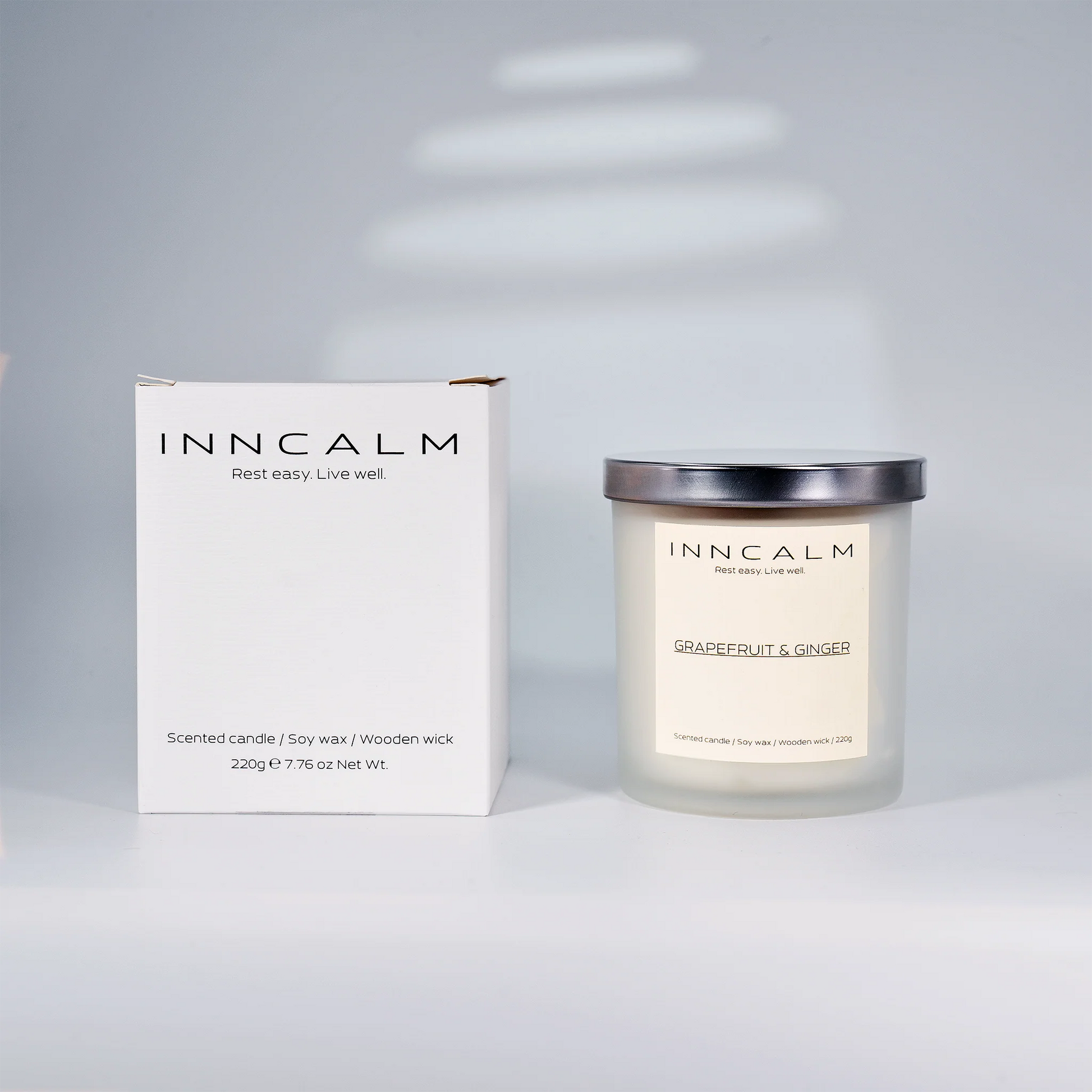 Premium eco-friendly packaging of the INNCALM Grapefruit & Ginger scented candle, ideal for gifting or self-care rituals