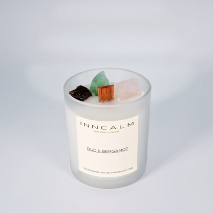INNCALM Oud & Bergamot luxury candle, rich fragrance with a warm, slightly spicy undertone, featuring a wooden wick.
