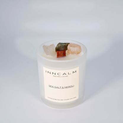 INNCALM Sea Salt & Neroli luxury candle, a coastal home fragrance with a calming, fresh scent, featuring a wooden wick.