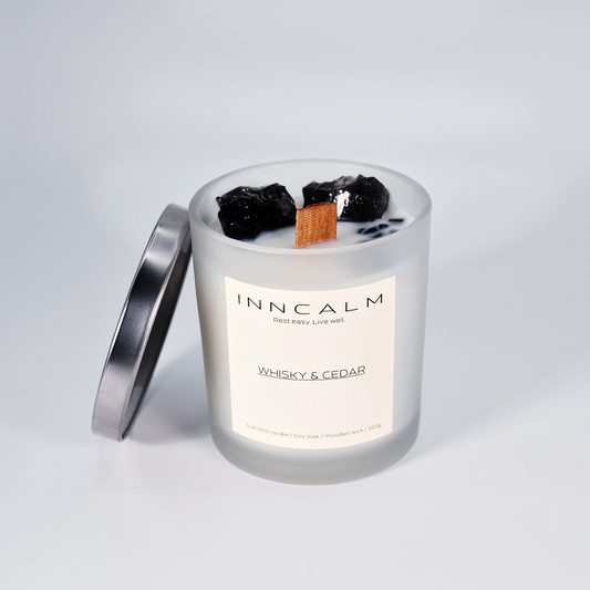 Luxury scented candle with a stylish glass lid, designed to preserve the deep, smoky fragrance of whiskey and cedar.